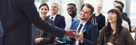 A presentation being delivered to a group of people in a professional workplace setting.