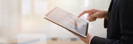 A person holding a tablet device in their hands.