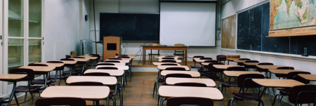 A classroom full of empty desks.