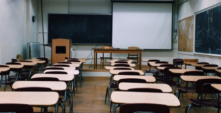 A classroom full of empty desks.